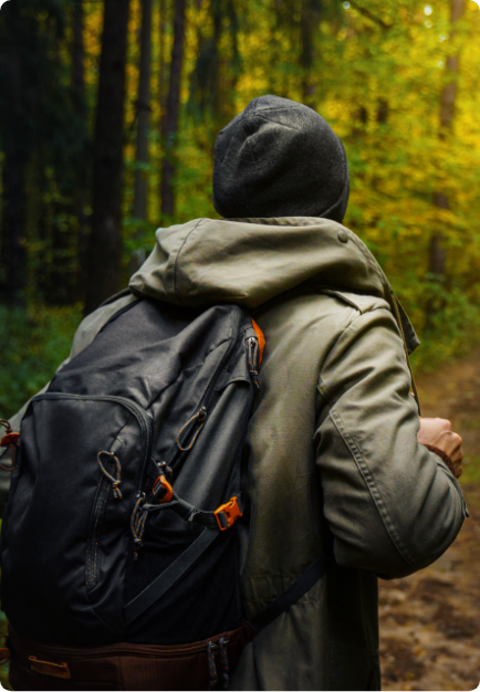 Man with a backpack walking through the woods